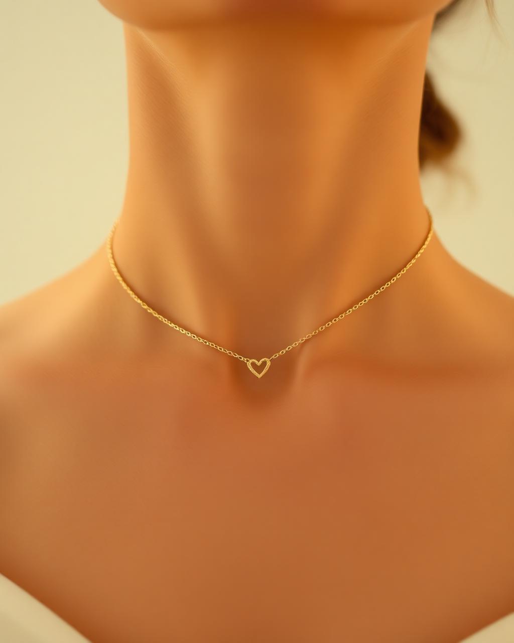 Model wearing a dainty gold heart pendant chain necklace